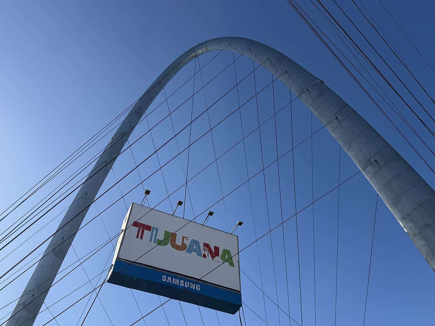 The Tijuana arch and monumental clock above the colorful city sign on Avenida Revolución